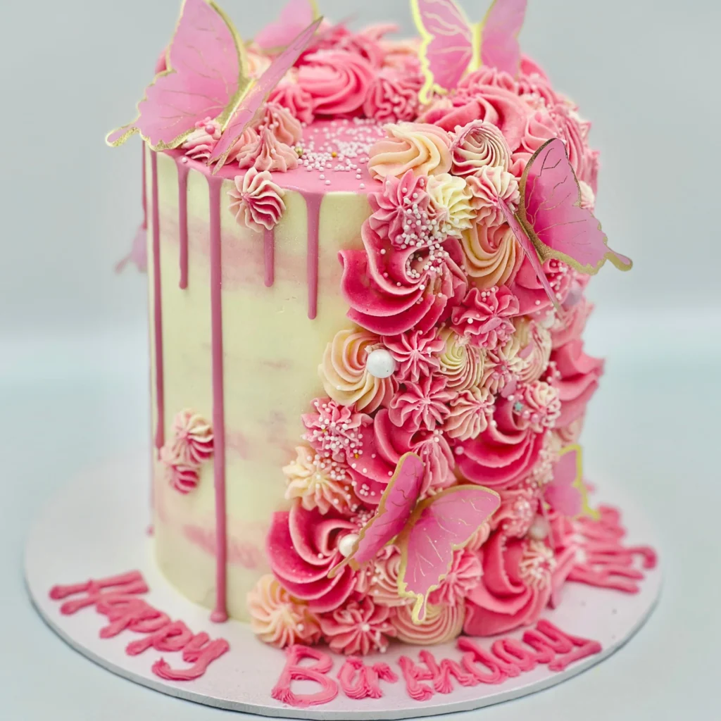 Butterfly cake design with pastel frosting and wafer paper butterflies on top