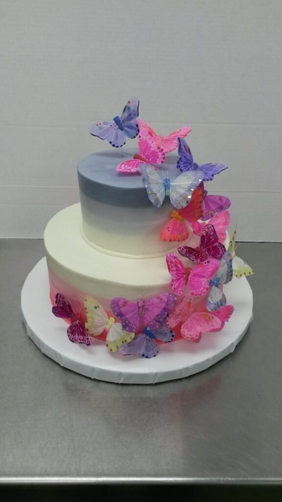 Elegant butterfly themed cake decorated with gold butterflies and white fondant