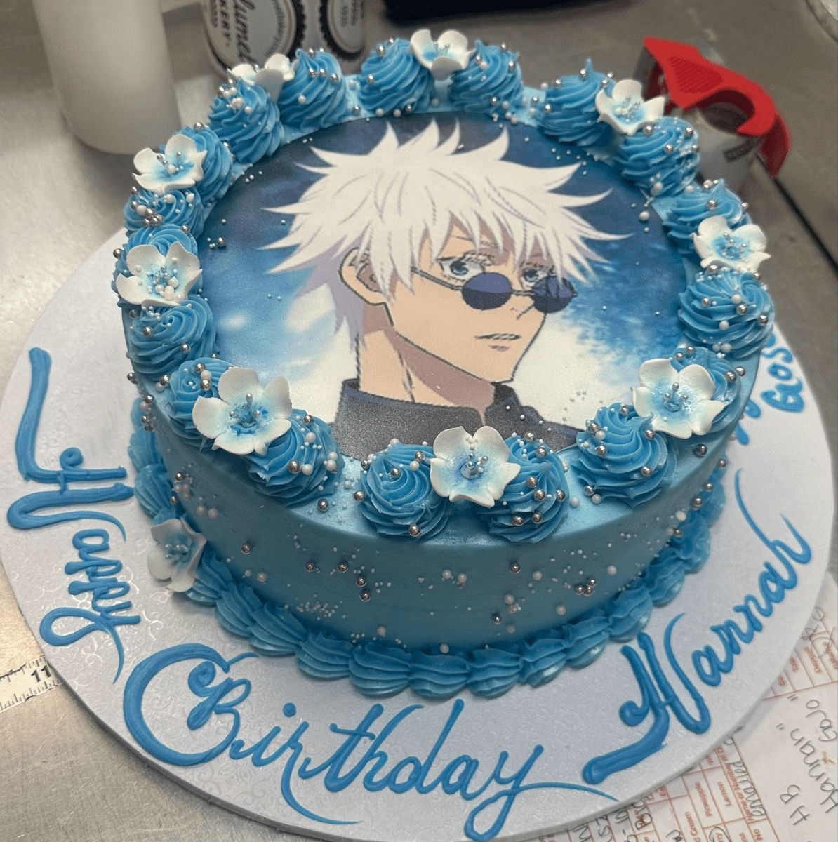 Hand-painted anime cake with edible art of popular characters on smooth fondant surface