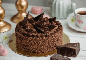 Whole chocolate truffle cake decorated with chocolate shavings and ganache drip