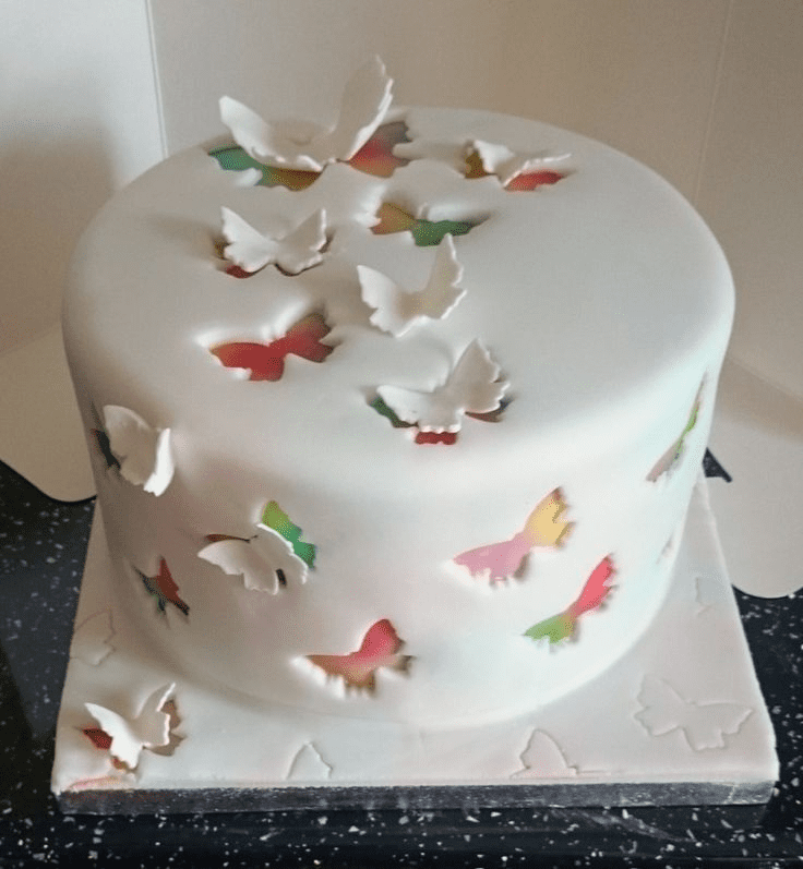 cake with dimensional butterfly embellishments creating a whimsical garden effect
