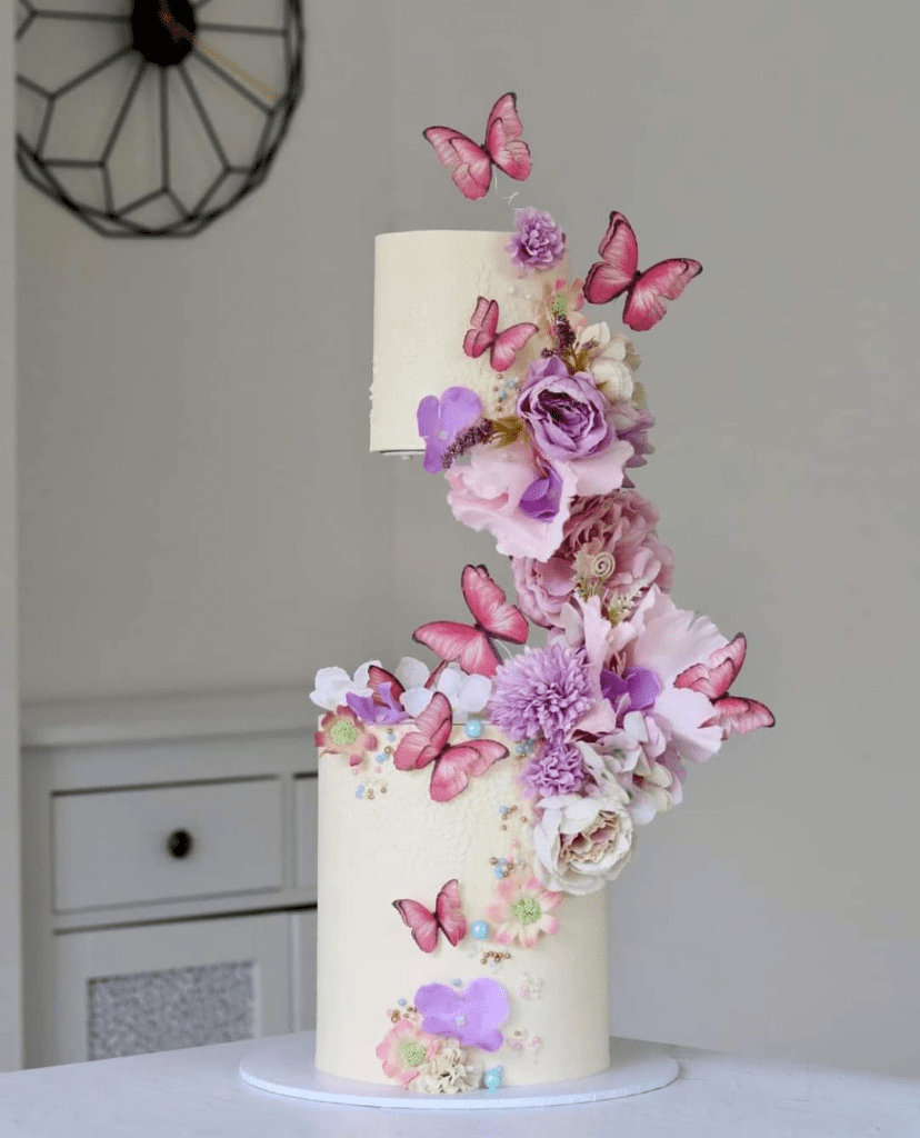 Cake decorated with 2-dimensional edible butterflies in various colors
